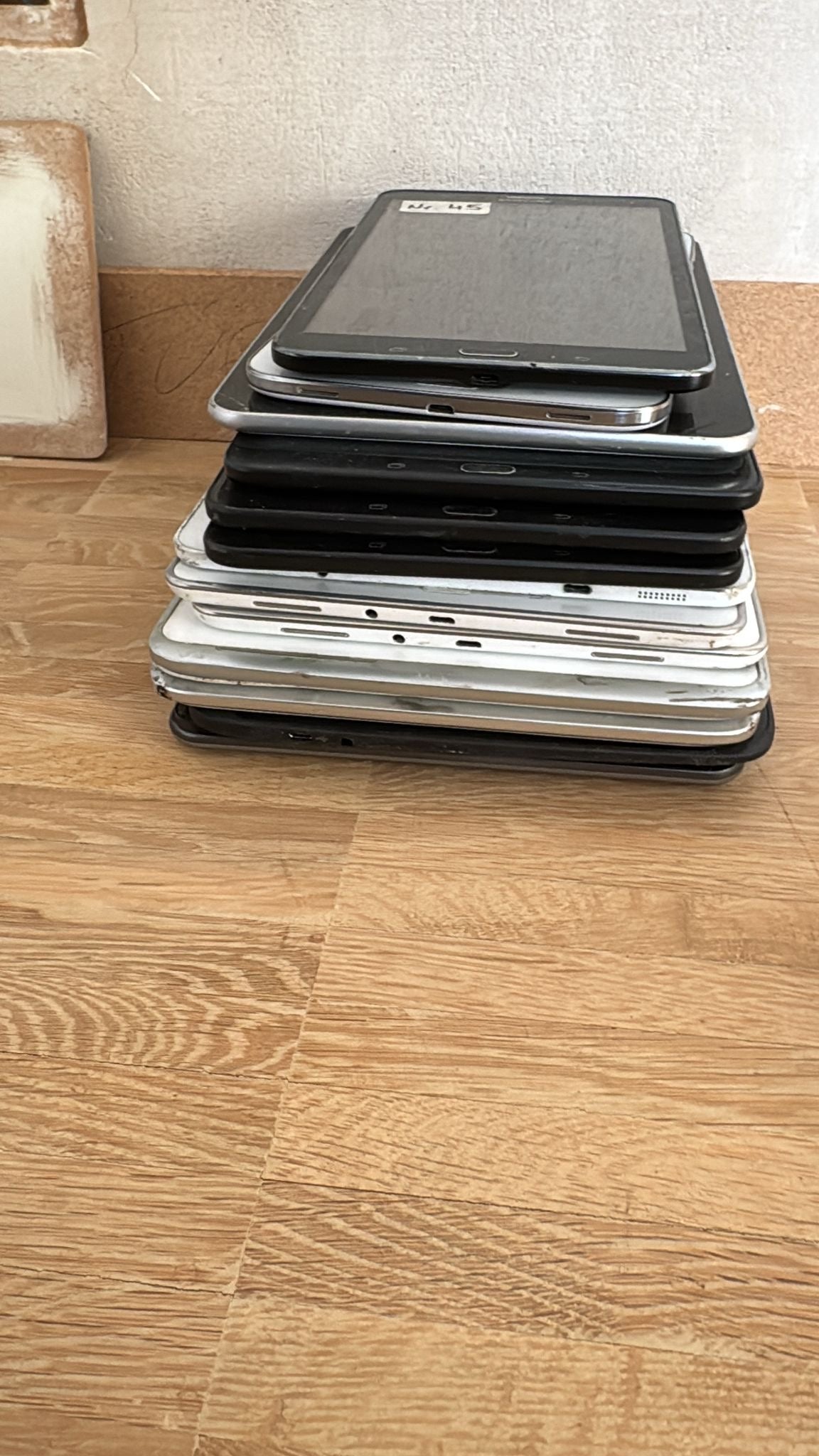 Stack of black and silver metal trays on a wooden surface